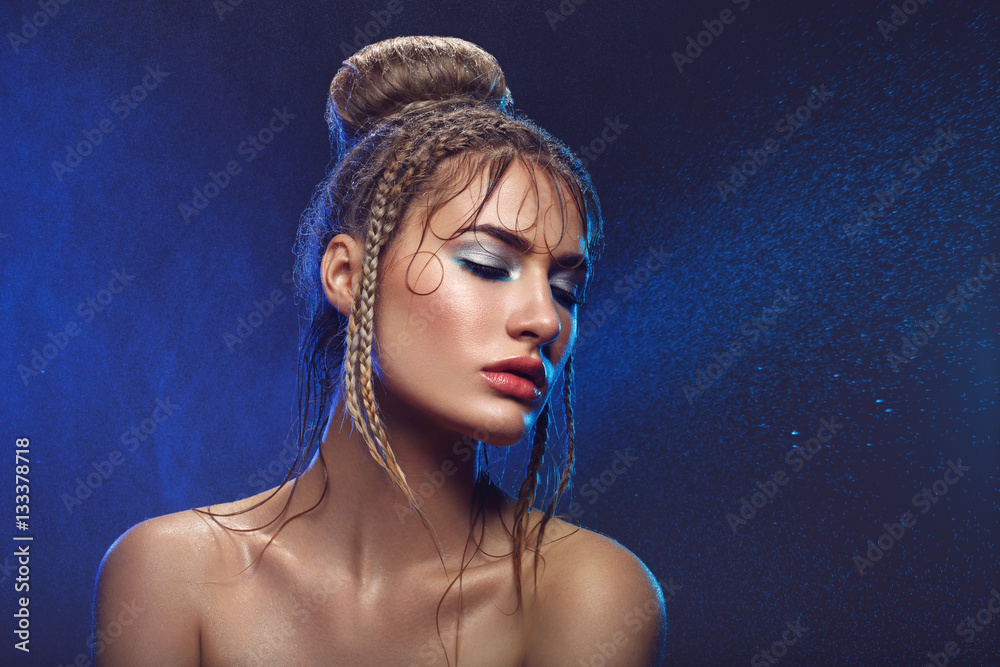Beautiful girl with blue makeup in water drops Beautiful girl with blue makeup in water drops