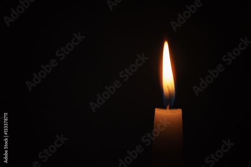 tall candle blown in the dark environment, shallow focus