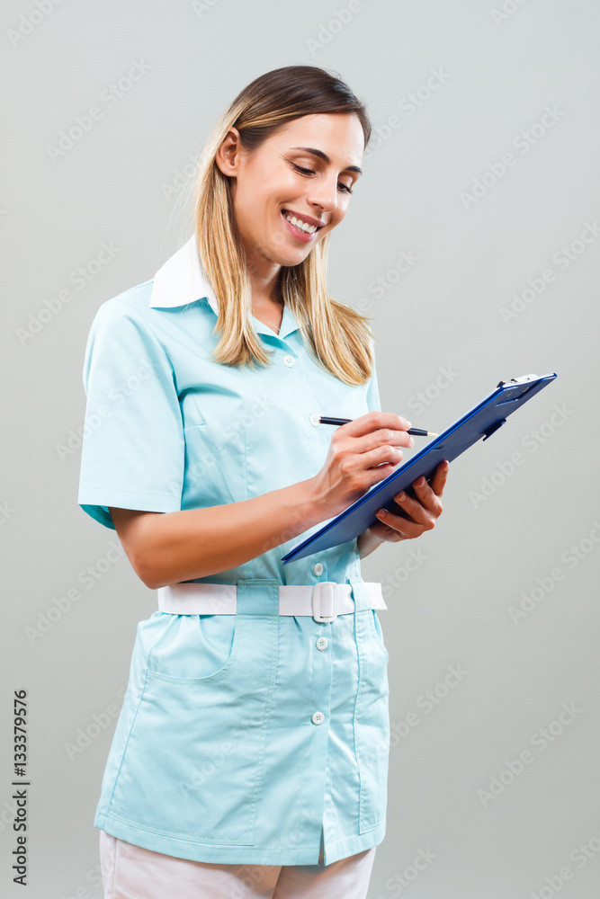 Portrait of beautiful nurse writing notes. Portrait of beautiful nurse writing notes.