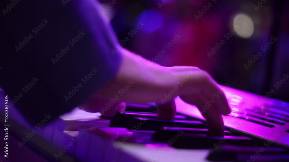 male hands playing the synthesizer