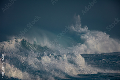 Huge waves crashing in ocean. Seascape environment background. Water texture with foam and splashes. Hawaiian surfing spots with nobody