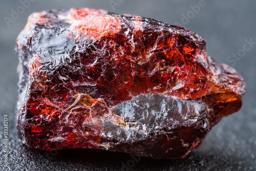 Uncut and rough deep red rhodolite garnet gemstone. photo
