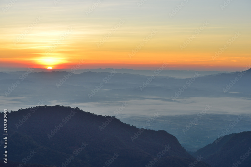 Sun rising on the sky over beautiful mountains