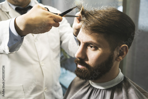 Close up of a man having his hair cut photo