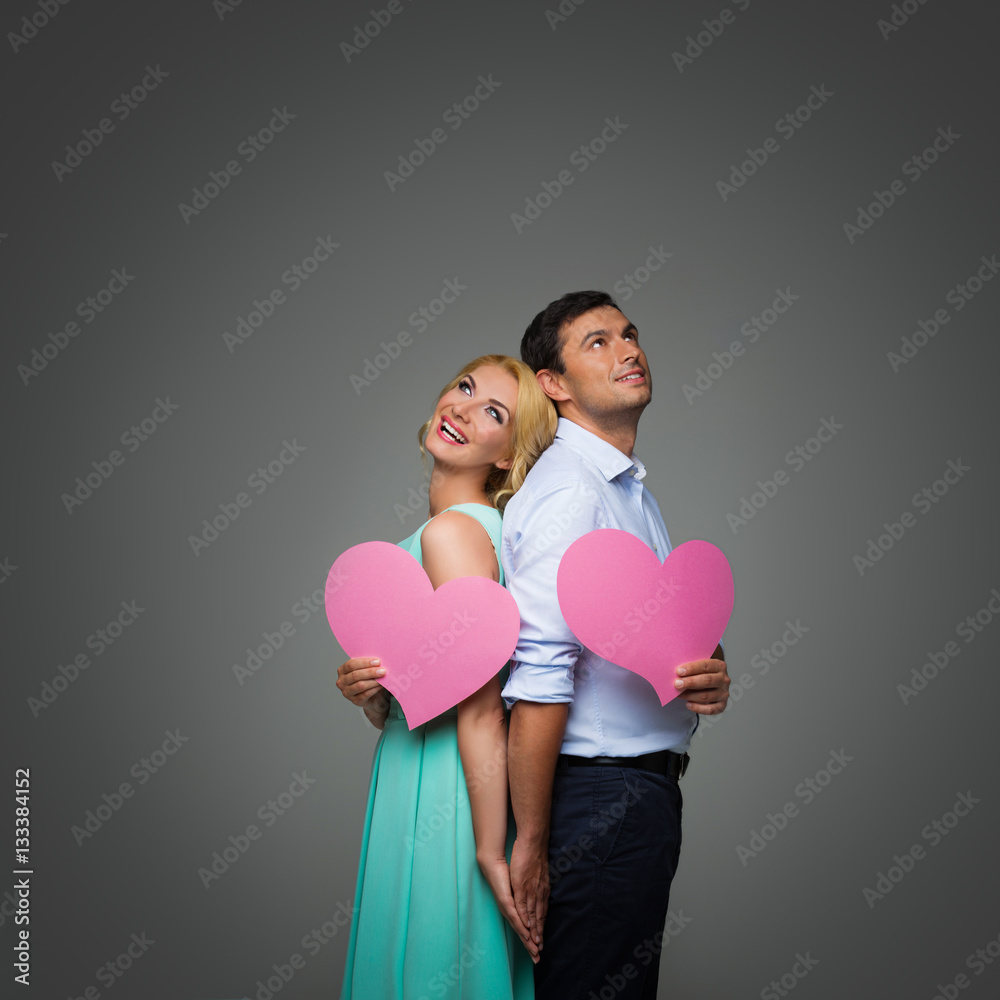 Beautiful couple holding pink hearts Beautiful couple holding pink hearts
