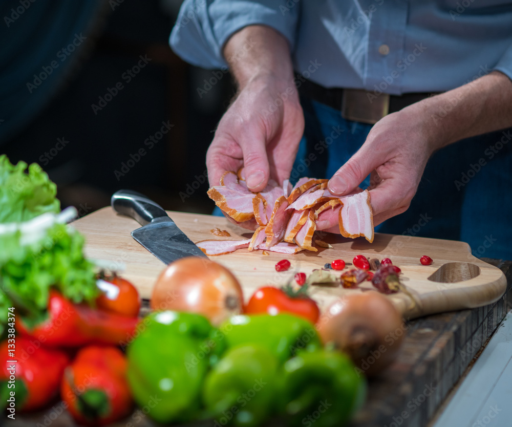 Man holding a sliced bacon