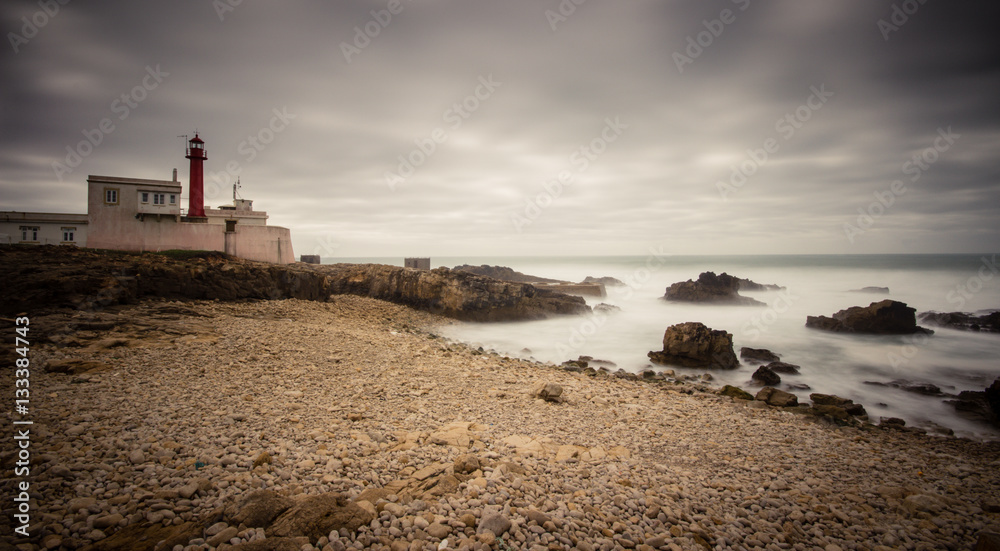 Lighthouse at cape Raso in Cascais, Portugal in a storm day