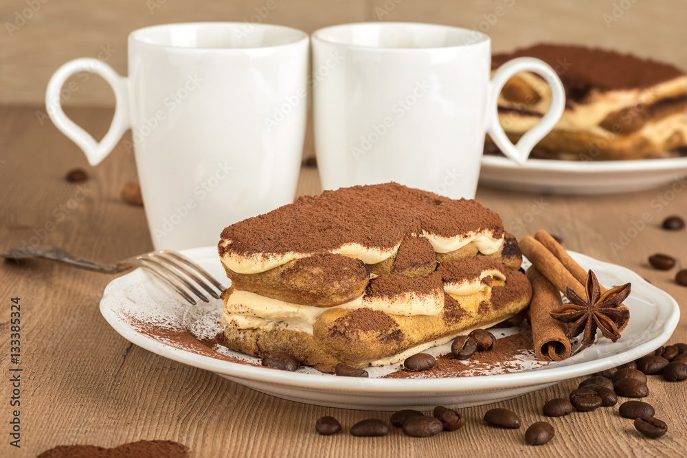 Tiramisu /
Still life with tiramisu cake in a white plates, cups of coffee and a coffee beans decoration Tiramisu /
Still life with tiramisu cake in a white plates, cups of coffee and a coffee beans decoration