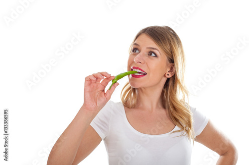 Eating a piece of hot paprika