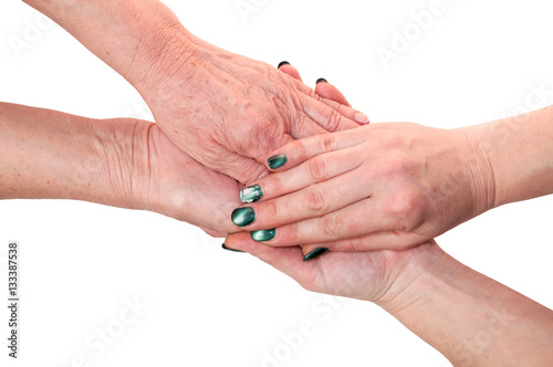 Hands of an elderly woman holding young hands. Isolated on white