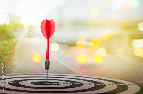 Close up shot red dart arrow on center of dartboard with transpo