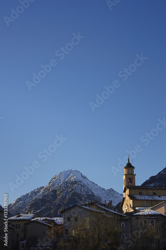 The Italian Maratime Alps with a local church at Entracque, Cuneo, Piemonte, Italy. The chuch in the foreground is in the village of Entracque. photo