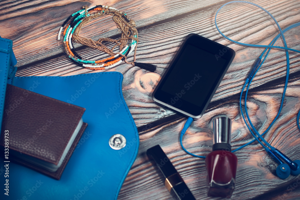 Lady purse stuff, smart phone, ear headphones, cosmetics, jewellery Lady purse stuff, smart phone, ear headphones, cosmetics, jewellery