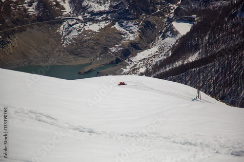 Tignes le Lac village and the dam from above in winter (snowblower), Alps, France 