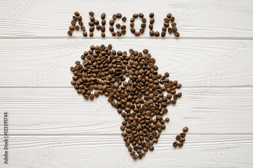 Map of the Africa made of roasted coffee beans and cup of coffee on white wooden textured background with space for text