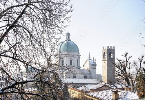 View of baroque church and medieval tower with snow. Brescia, Italy.