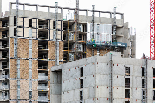 Labours work on lift platform on new development in London Dockl photo