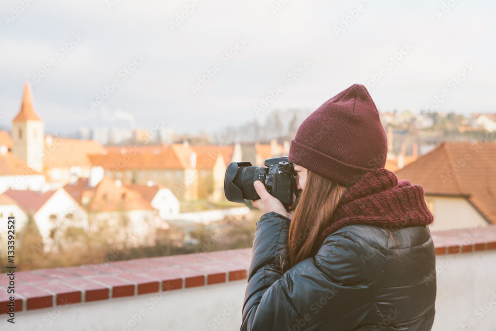 beautiful young female tourist photographing views of the European city