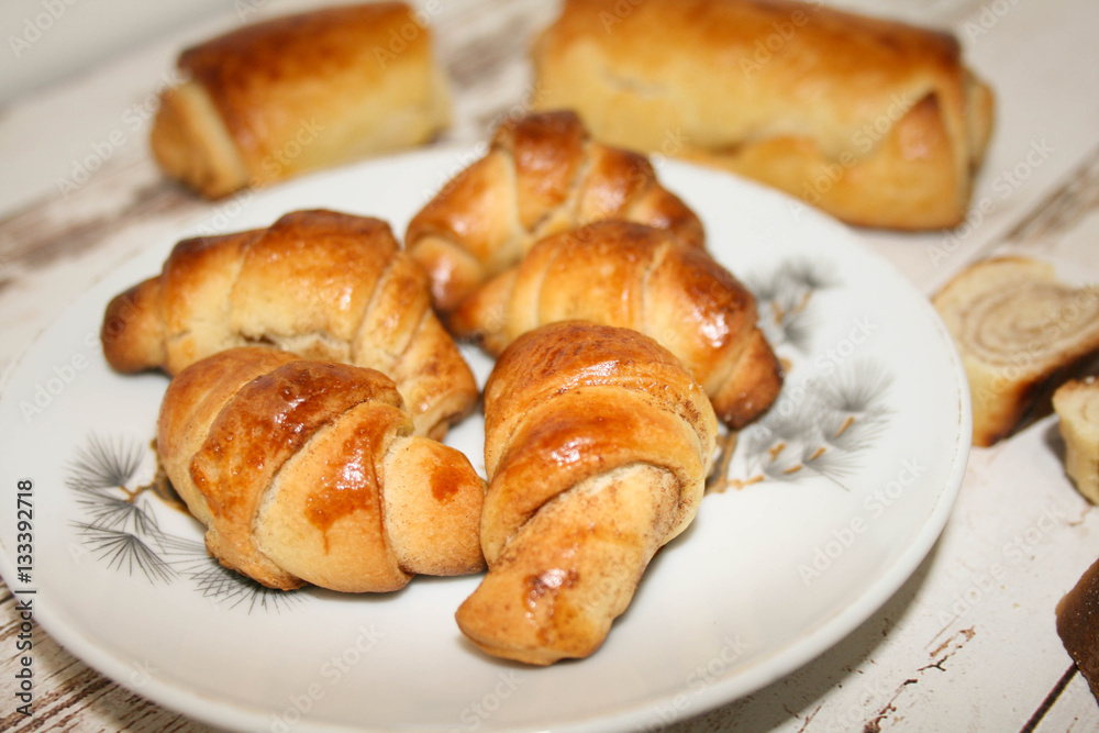 Homemade breads or bun on wood background, croissant puff cinnamon, breakfast food Homemade breads or bun on wood background, croissant puff cinnamon, breakfast food