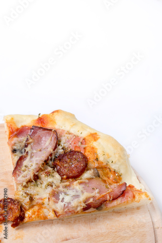 Flat lay overview of pizza with domestic ham sirloin and sausage