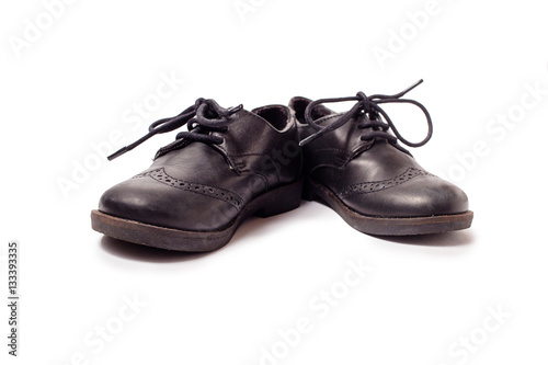 Black worn leather shoes on white background