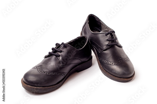 Black worn leather shoes on white background