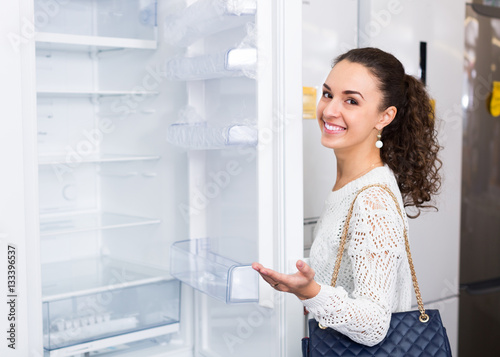 brunette choosing new refrigerator