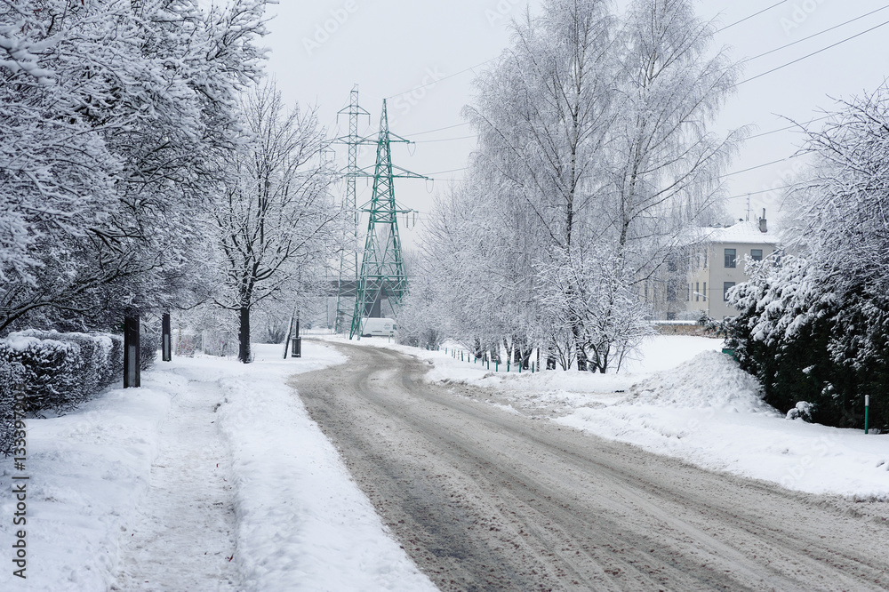 Road in winter forest covered with snow and electric wire towers on a background. Road in winter forest covered with snow and electric wire towers on a background.