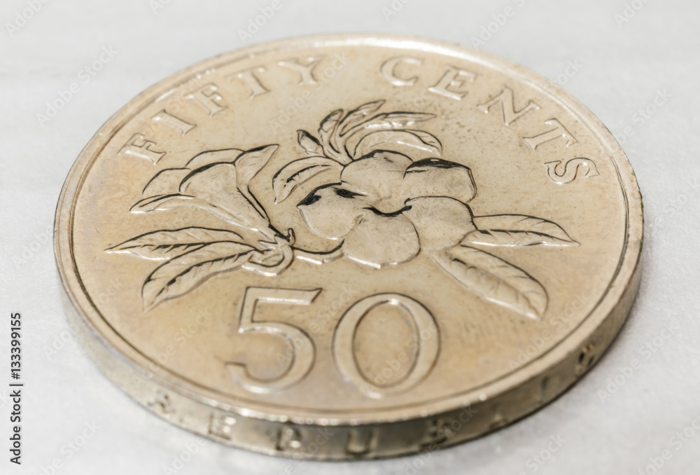 singapore fifty cents coin with yellow allamanda flower closeup singapore fifty cents coin with yellow allamanda flower closeup