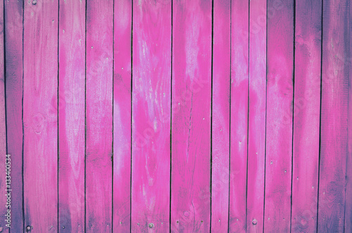 pink, violet old wooden fence. wood palisade background. planks texture