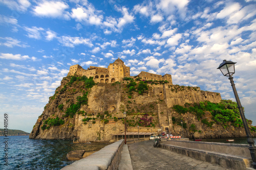 View on Aragonese castle at sunset, Ischia, Italy photo