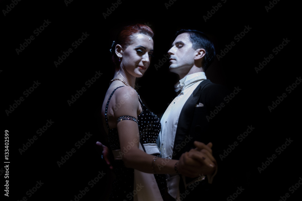 couple dancing on a dark background