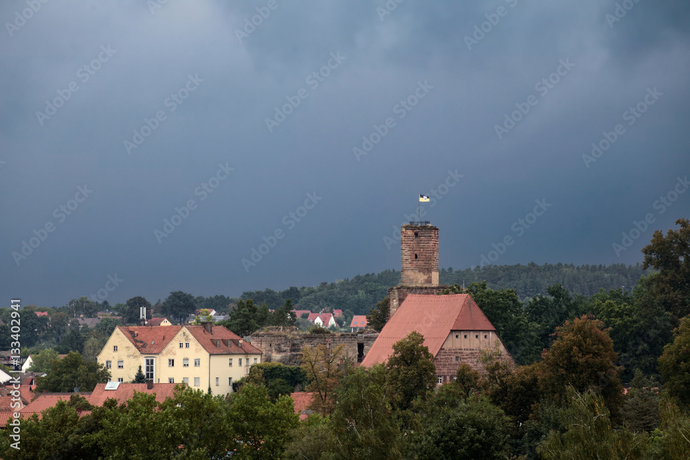 Hilpoltstein with castle ruin under stormy sky