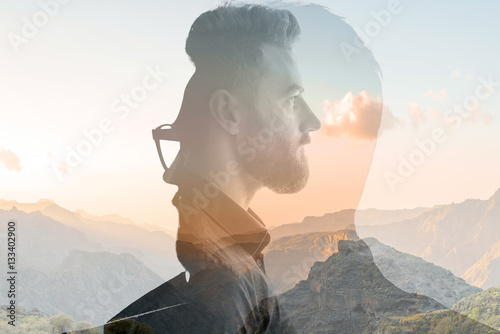 Triple exposure portrait of a businessman combinated with beautiful mountain landscape on the sunset photo