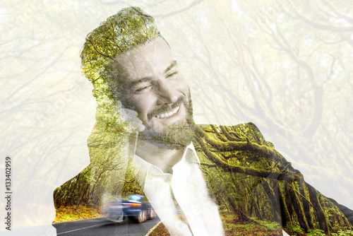 Double exposure portrait of a businessman talking with phone combinated with forest landscape photo