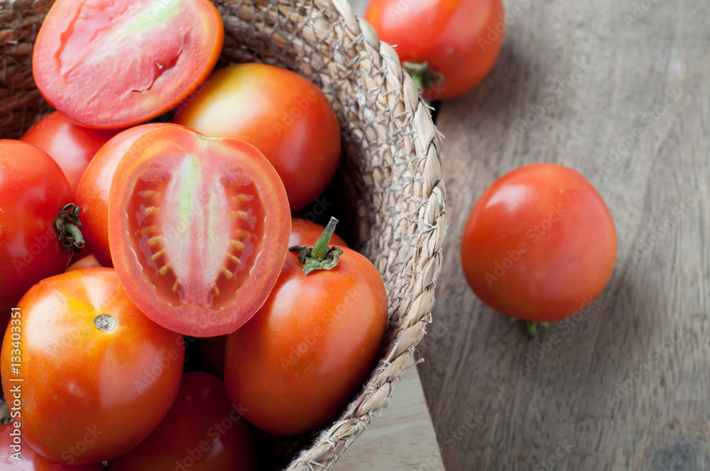 kitchen table with slice fresh tomatoes on wood basket. kitchen table with slice fresh tomatoes on wood basket.