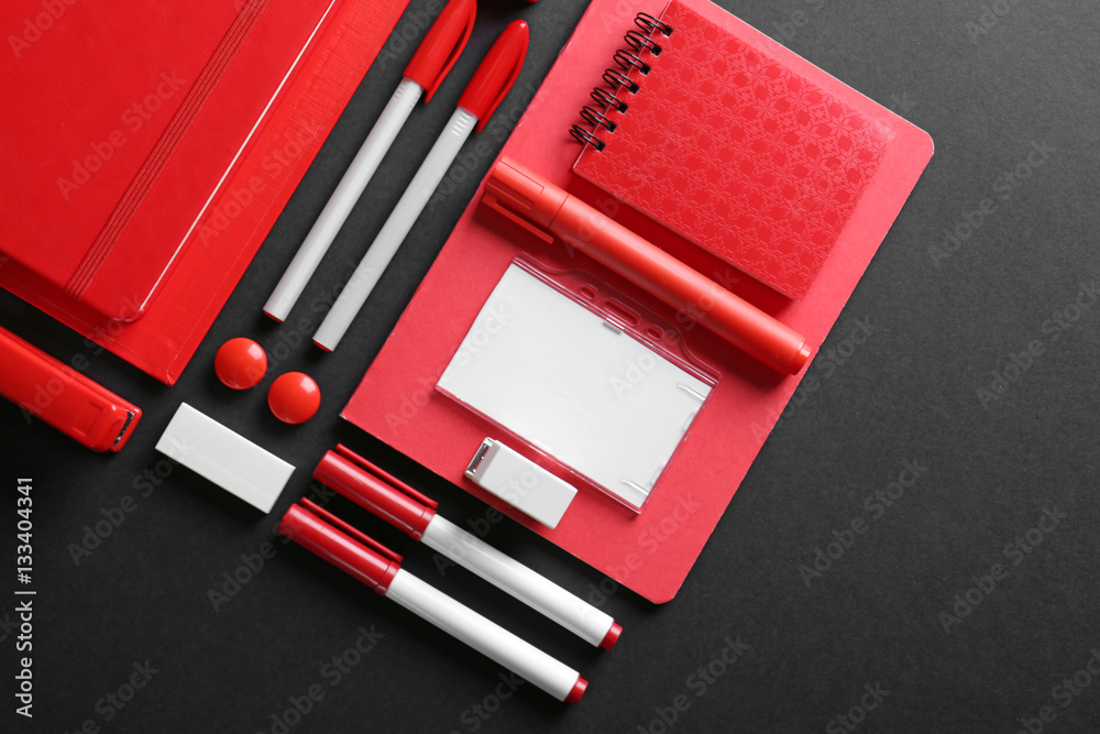 Flat lay of red stationery on black background Flat lay of red stationery on black background