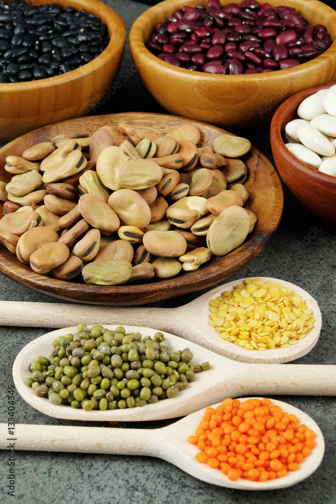 Dried various beans and lentils in wood bowls and spoons. Dried various beans and lentils in wood bowls and spoons.