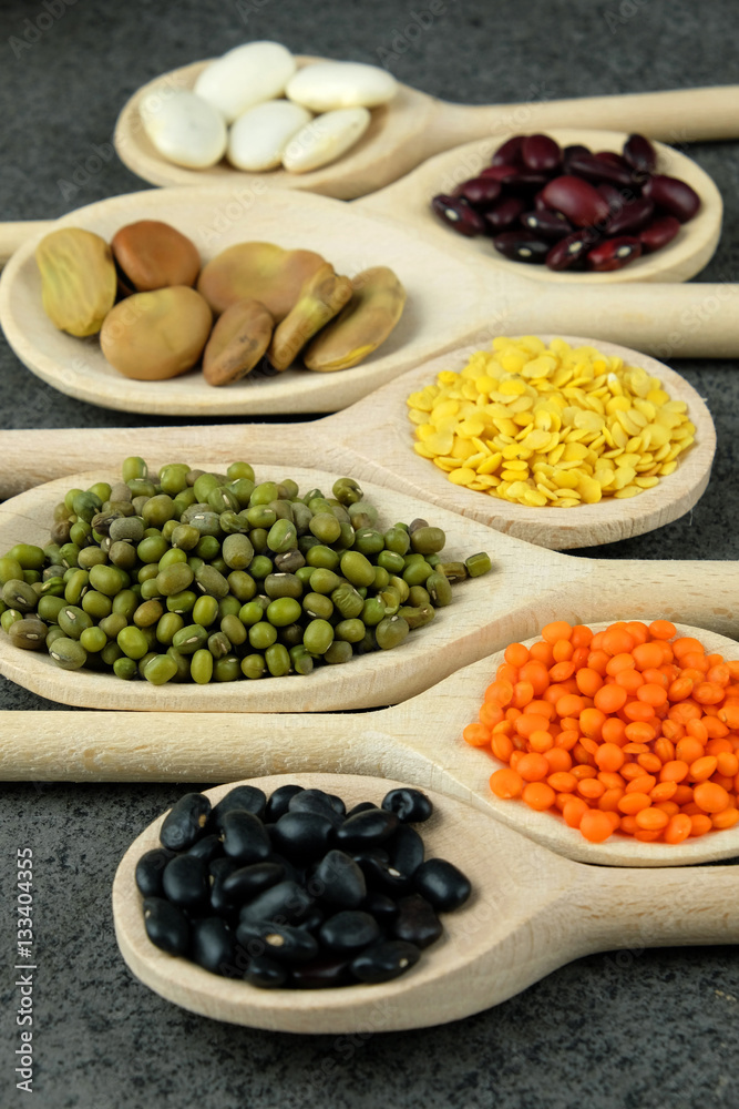 Dried various beans and lentils in wooden spoons. Dried various beans and lentils in wooden spoons.