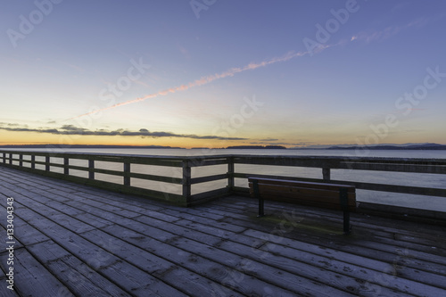 Bench on a frosty dock with strong lines and a colorful sky.Vancouver Island Canada © Paul