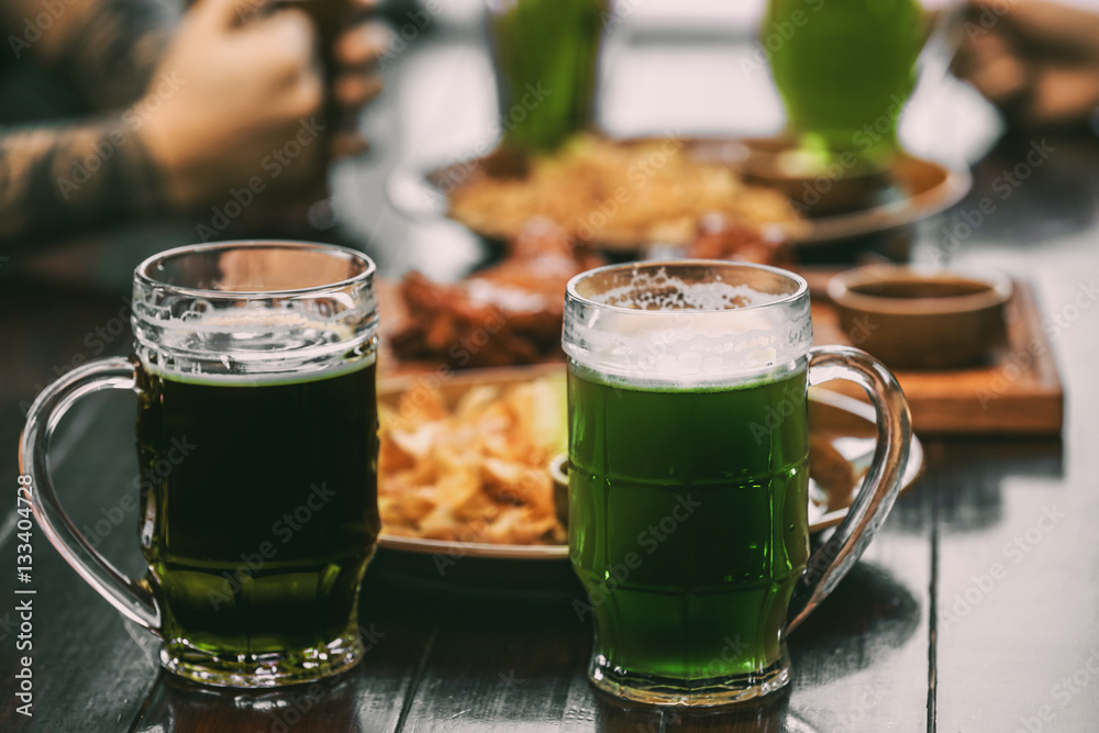 Mugs with cold beer on table in pub Mugs with cold beer on table in pub