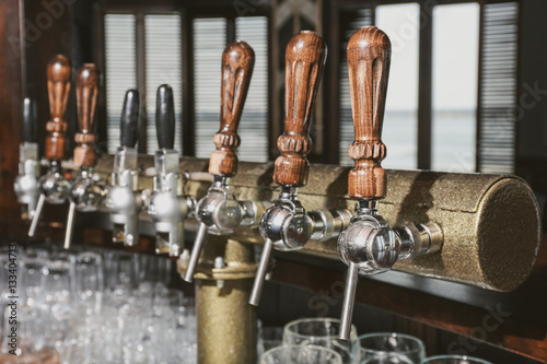 Draft beer taps in modern bar