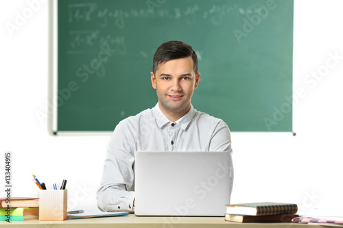 Handsome young teacher work...