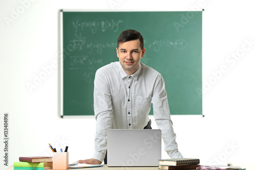 Handsome young teacher work...
