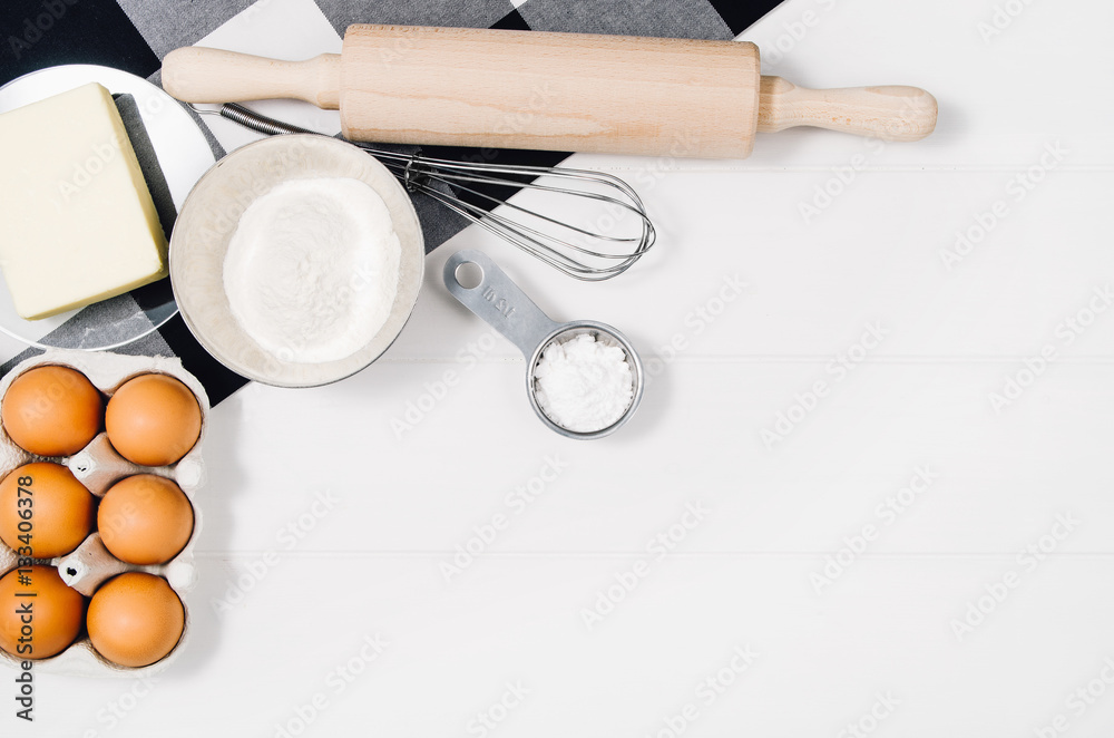 Baking a cake or pizza ingredients background. Top view photograph with kitchen utensils on vintage, natural, white, wooden background.