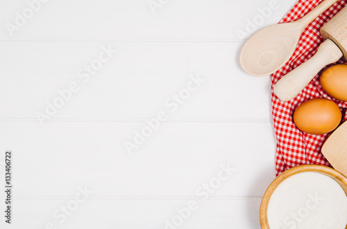 Baking a cake or pizza ingredients background. Top view photograph with kitchen utensils on vintage, natural, white, wooden background.