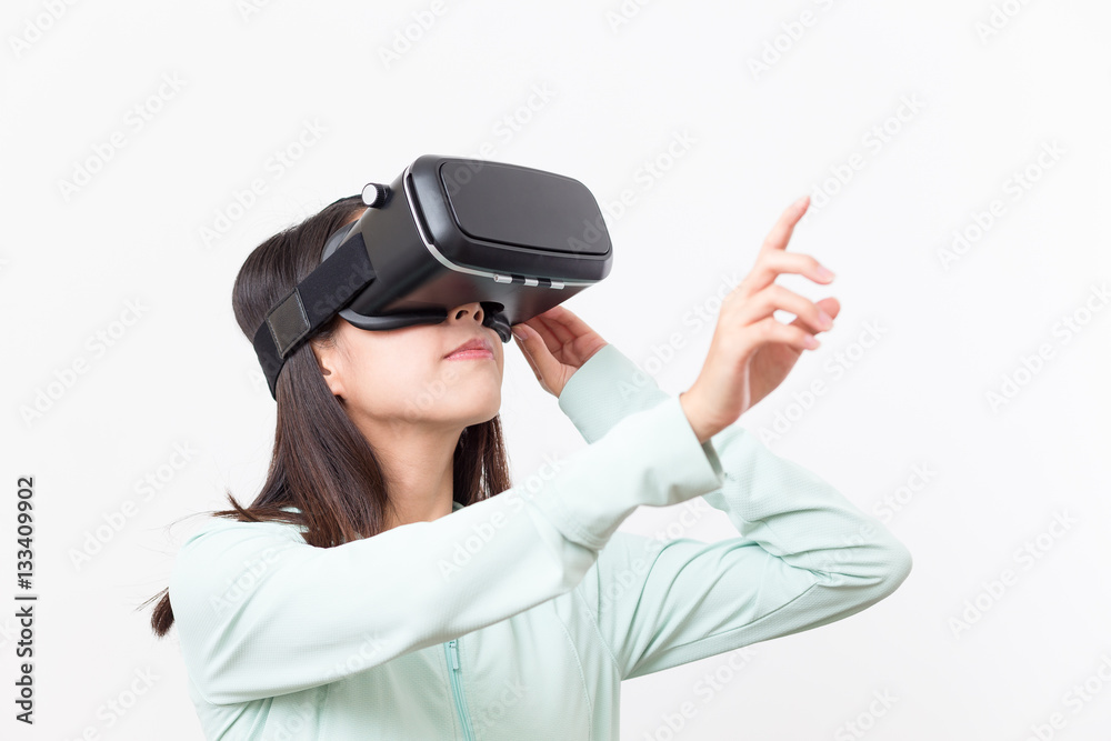 Woman using VR device and finger pointing up Woman using VR device and finger pointing up