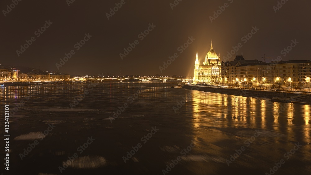 Parliament at nighttime with icy Danube