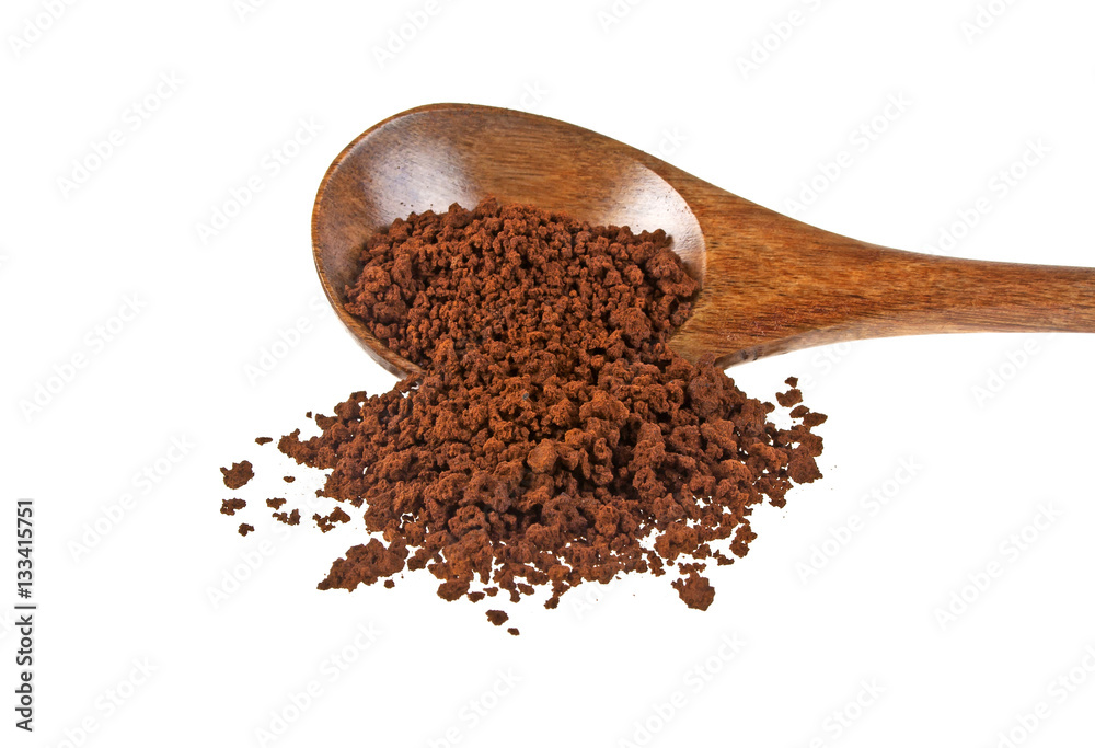 Instant coffee grains in wooden spoon on a white background Instant coffee grains in wooden spoon on a white background