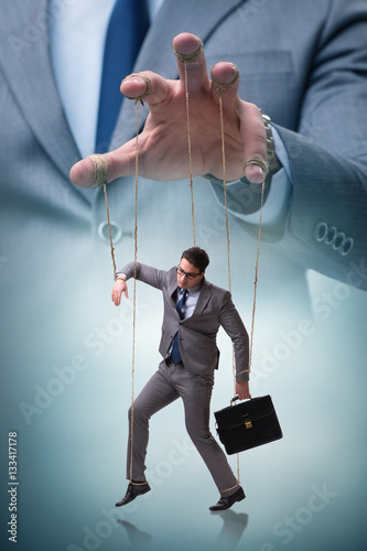 Fotografía Businessman puppet being manipulated by boss